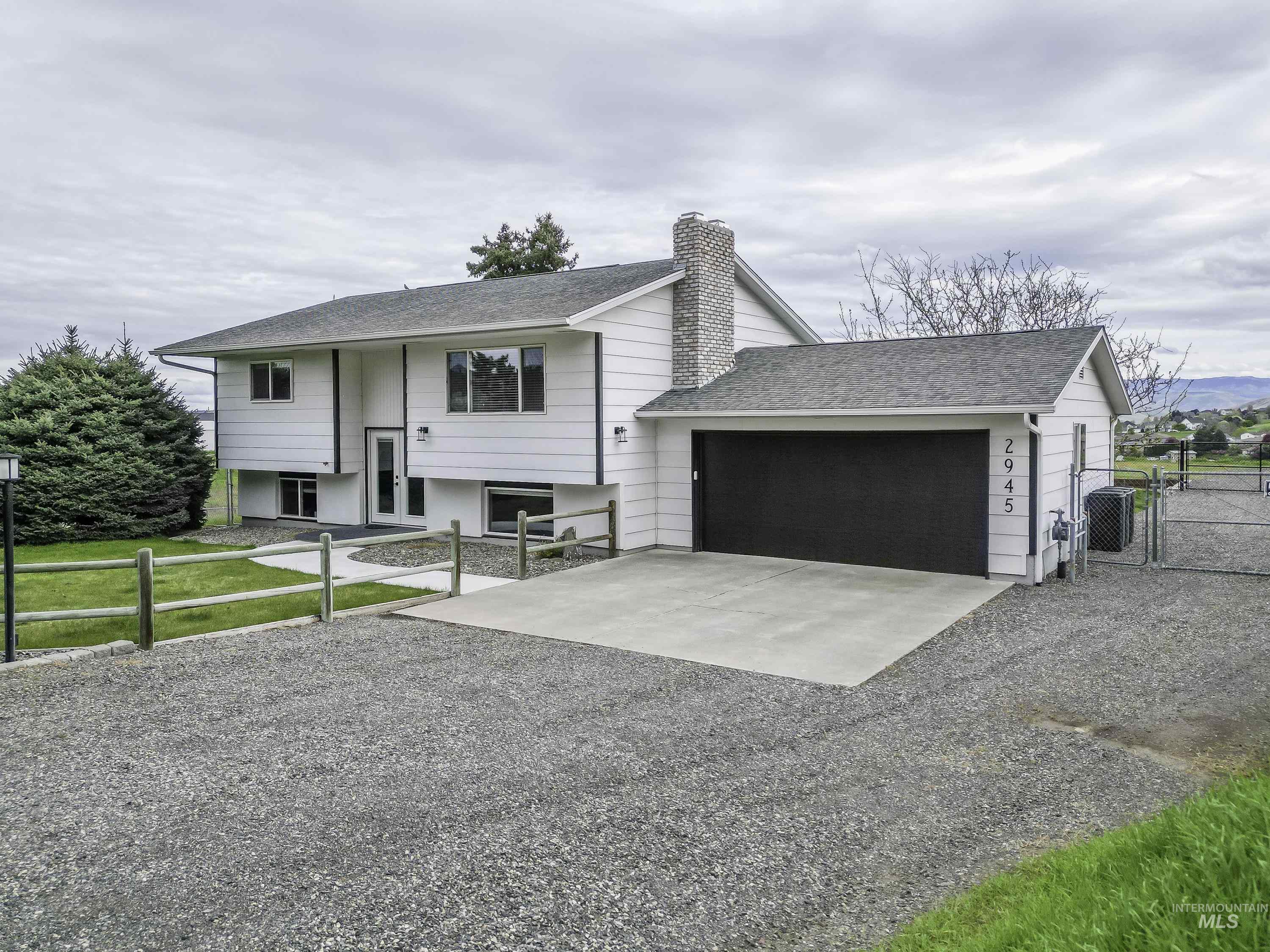 2945 25th Street Clarkston, WA 99403 - Photo 22 of 46 Split foyer home with a gate, driveway, a chimney, a shingled roof, and a garage