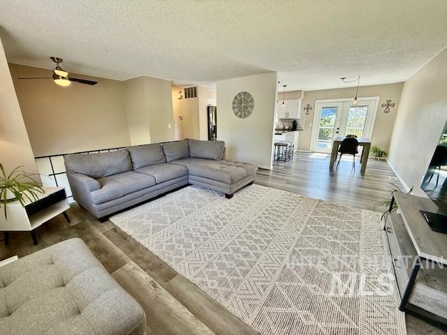 2945 25th Street Clarkston, WA 99403 - Photo 25 of 46 Living room with light wood-style flooring, a textured ceiling, and a ceiling fan
