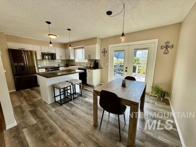 2945 25th Street Clarkston, WA 99403 - Photo 29 of 46 Dining area featuring french doors, dark wood-type flooring, and a textured ceiling