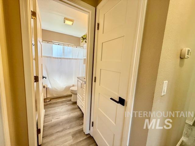 2945 25th Street Clarkston, WA 99403 - Photo 46 of 46 Full bathroom featuring vanity, light wood-style flooring, and a shower with shower curtain