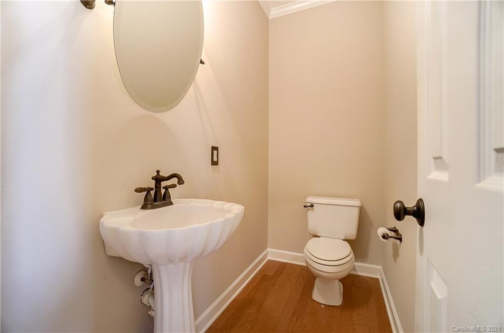 7064 Harbor Court Tega Cay, SC 29708 - Photo 18 of 48 a bathroom with a toilet sink and mirror