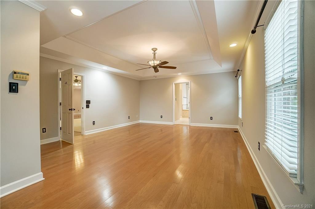 7064 Harbor Court Tega Cay, SC 29708 - Photo 21 of 48 a view of empty room with wooden floor and fan