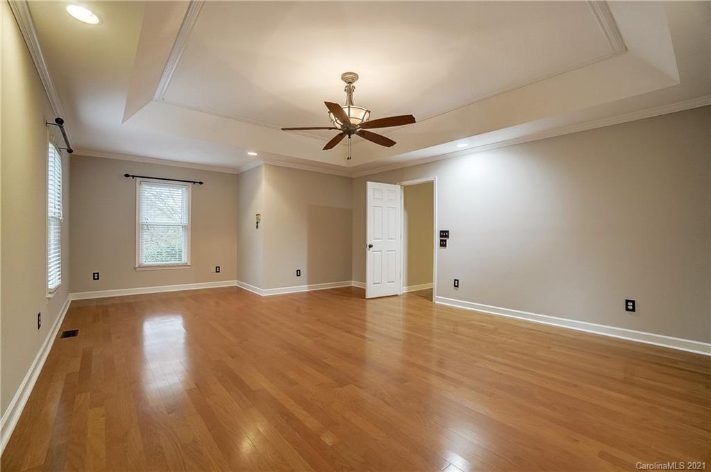 7064 Harbor Court Tega Cay, SC 29708 - Photo 22 of 48 a view of an empty room with window and wooden floor