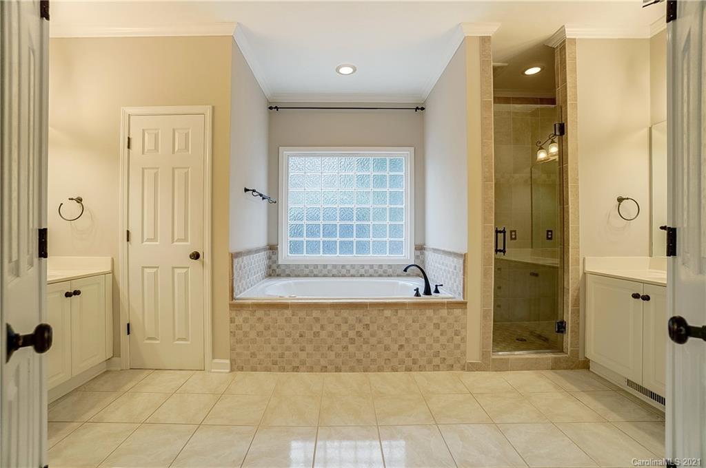 7064 Harbor Court Tega Cay, SC 29708 - Photo 23 of 48 a bathroom with a bathtub and a shower