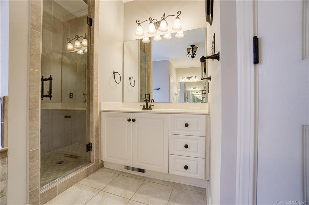 7064 Harbor Court Tega Cay, SC 29708 - Photo 25 of 48 a bathroom with a shower a sink and a mirror