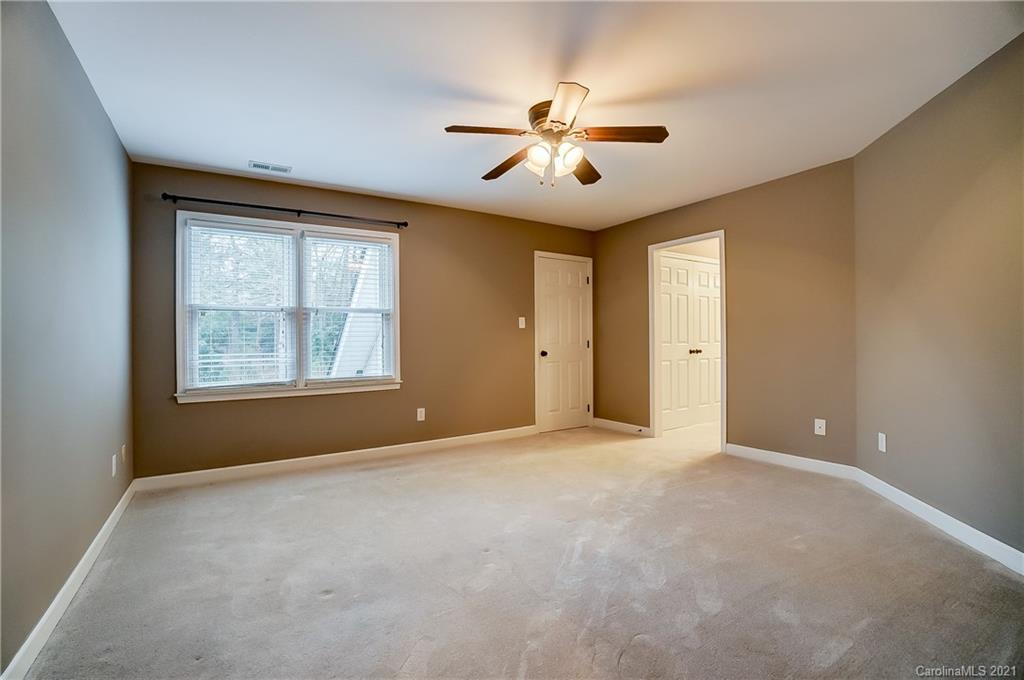 7064 Harbor Court Tega Cay, SC 29708 - Photo 32 of 48 an empty room with windows and fan
