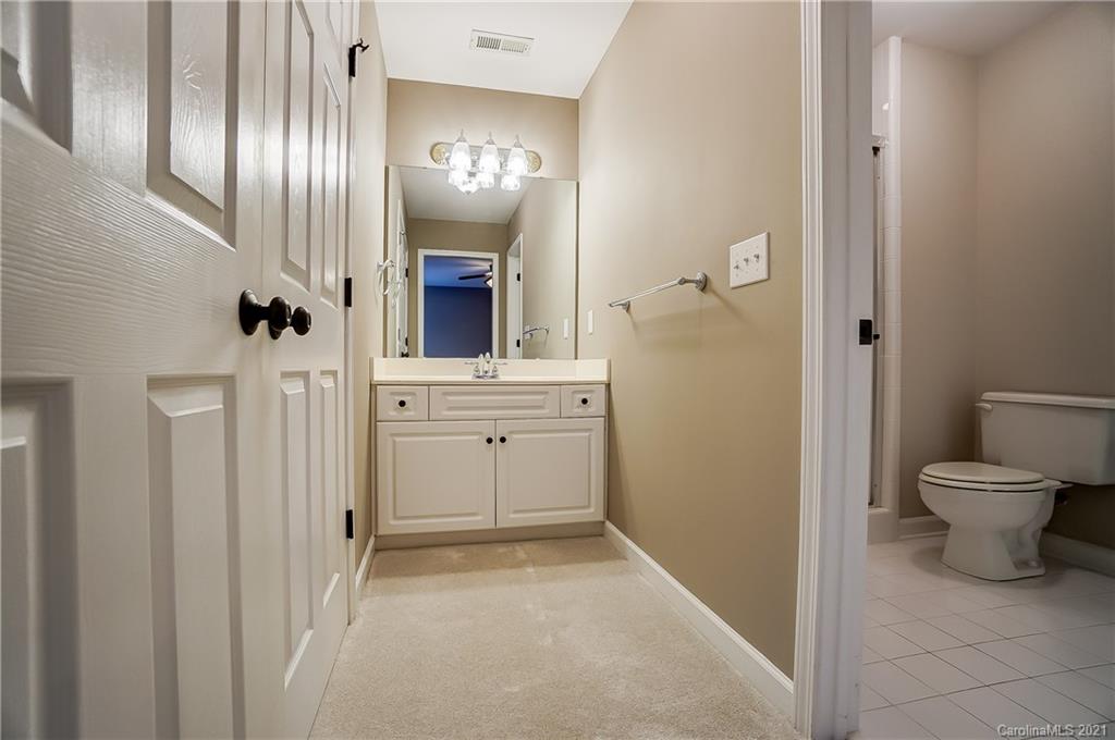 7064 Harbor Court Tega Cay, SC 29708 - Photo 33 of 48 a bathroom with a toilet a sink and mirror