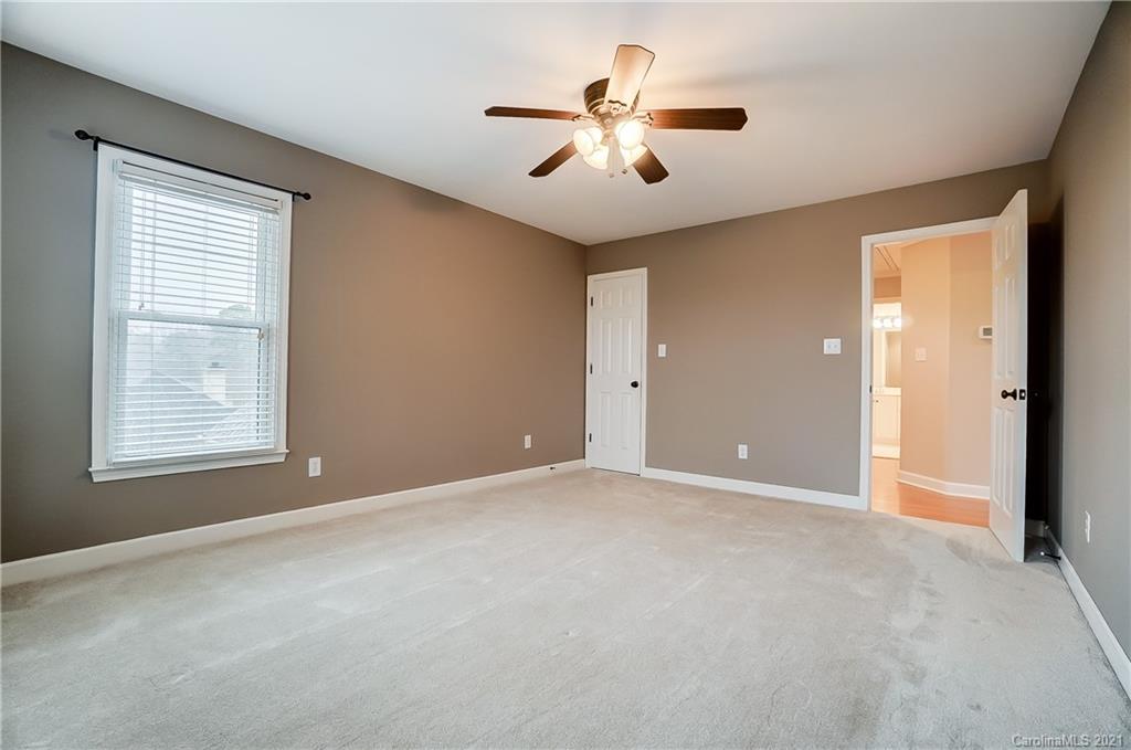 7064 Harbor Court Tega Cay, SC 29708 - Photo 39 of 48 an empty room with windows and ceiling fan