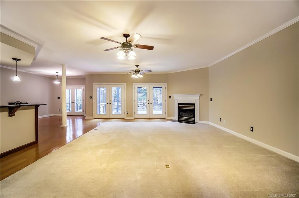 7064 Harbor Court Tega Cay, SC 29708 - Photo 6 of 48 a view of an empty room with a fireplace and a window