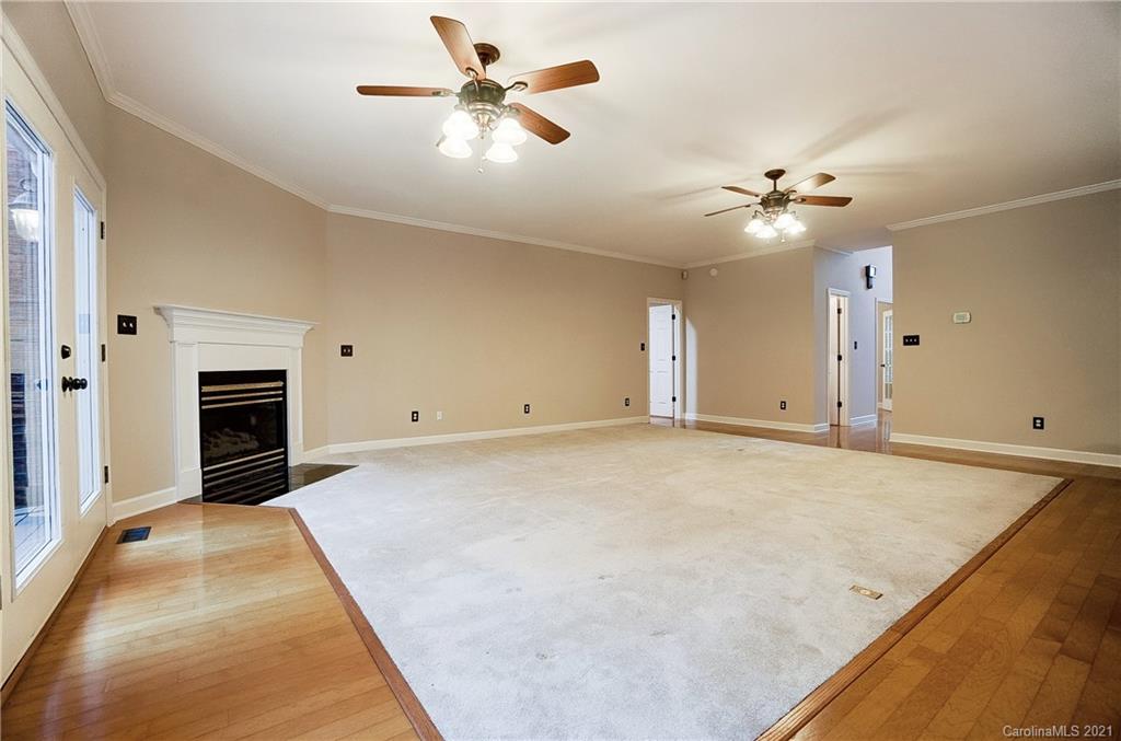 7064 Harbor Court Tega Cay, SC 29708 - Photo 7 of 48 wooden floor in an empty room with a ceiling fan