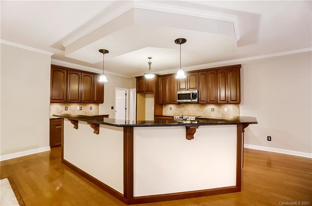 7064 Harbor Court Tega Cay, SC 29708 - Photo 9 of 48 a kitchen with stainless steel appliances granite countertop a sink a stove and a refrigerator