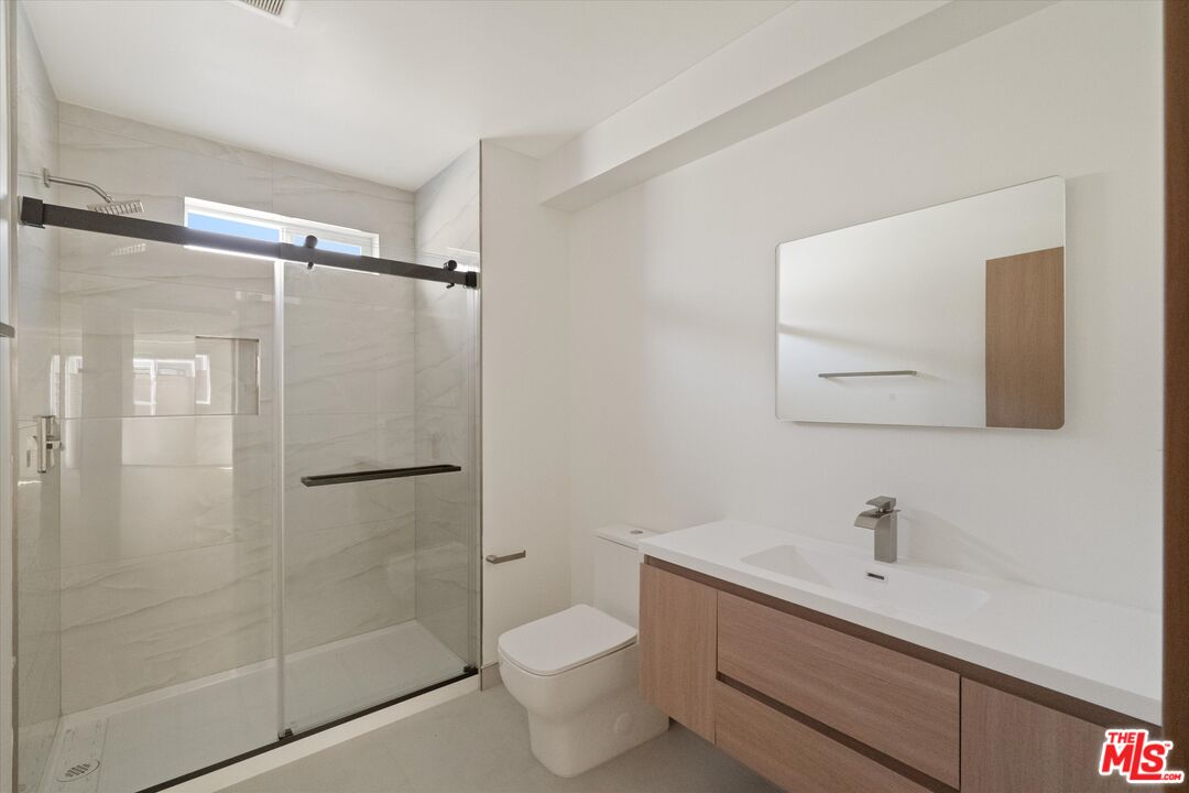 15207 Morrison Street Sherman Oaks, CA 91403 - Photo 11 of 34 a bathroom with a shower toilet and sink
