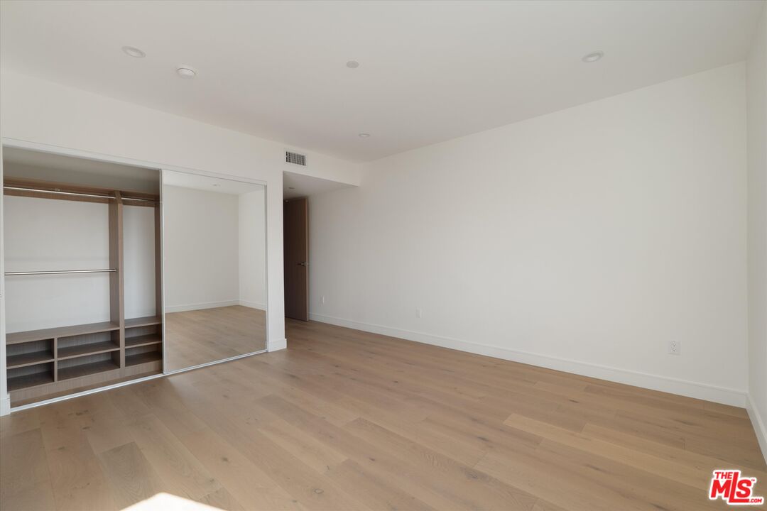 15207 Morrison Street Sherman Oaks, CA 91403 - Photo 13 of 34 an empty room with wooden floor and sliding door