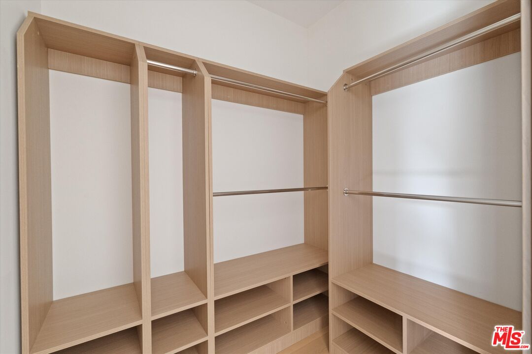 15207 Morrison Street Sherman Oaks, CA 91403 - Photo 14 of 34 a view of walk in closet with empty racks