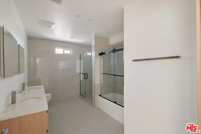 a bathroom with a shower and a sink