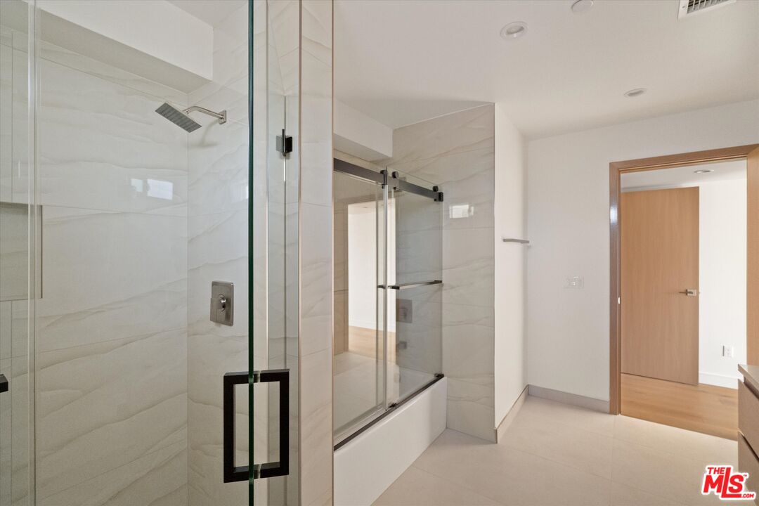 15207 Morrison Street Sherman Oaks, CA 91403 - Photo 16 of 34 a bathroom with a shower and a glass door