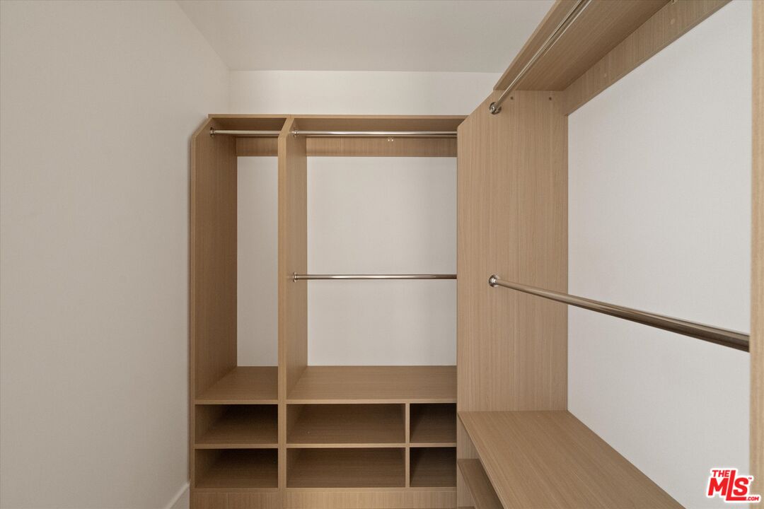 15207 Morrison Street Sherman Oaks, CA 91403 - Photo 19 of 34 a view of walk in closet with empty racks