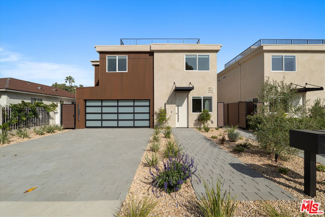 15207 Morrison Street Sherman Oaks, CA 91403 - Photo 2 of 34 a front view of a house with a yard and garage