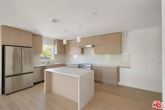 a utility room with cabinets washer and dryer