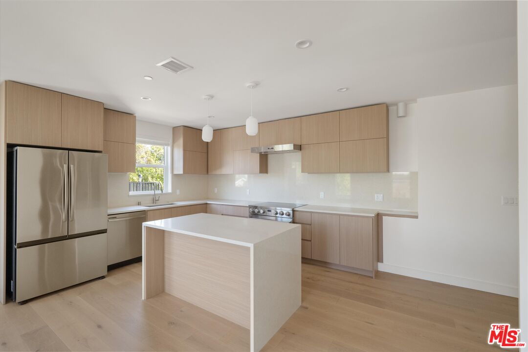 15207 Morrison Street Sherman Oaks, CA 91403 - Photo 28 of 34 a utility room with cabinets washer and dryer