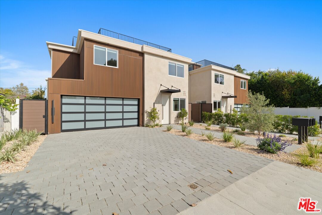 15207 Morrison Street Sherman Oaks, CA 91403 - Photo 3 of 34 a front view of a house with a yard and garage