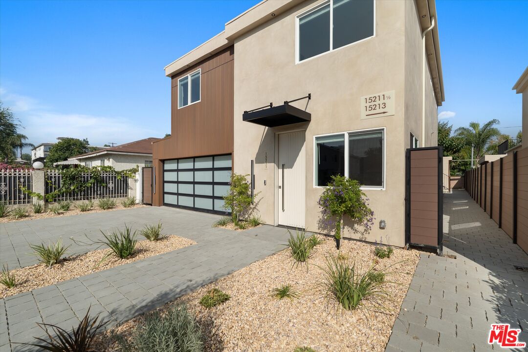 15207 Morrison Street Sherman Oaks, CA 91403 - Photo 4 of 34 a front view of a house with a yard