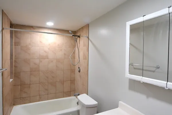 a bathroom with a bathtub and a shower