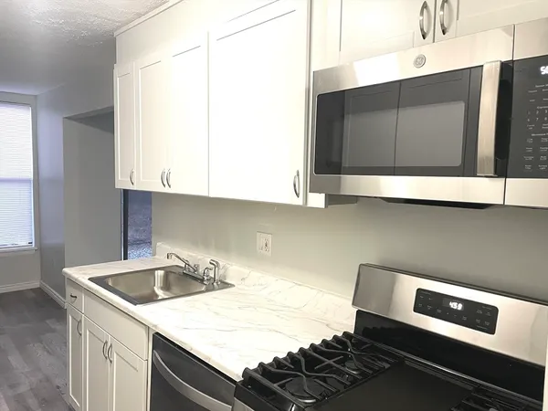 a kitchen with a sink and cabinets