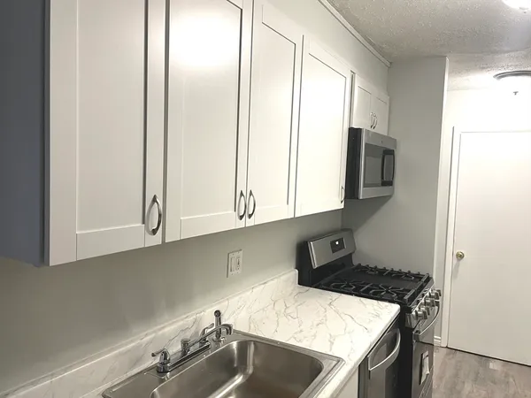 a kitchen with a sink cabinets and appliances