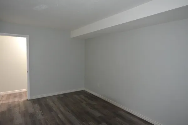 a view of an empty room and wooden floor
