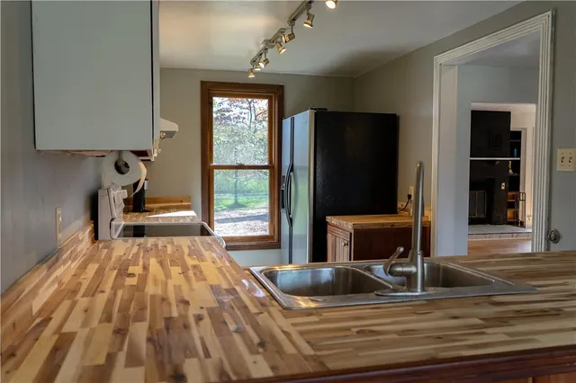 a living room with a bed and a flat screen tv
