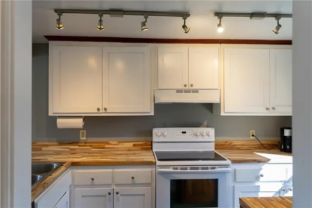 a kitchen with a stove a microwave and refrigerator