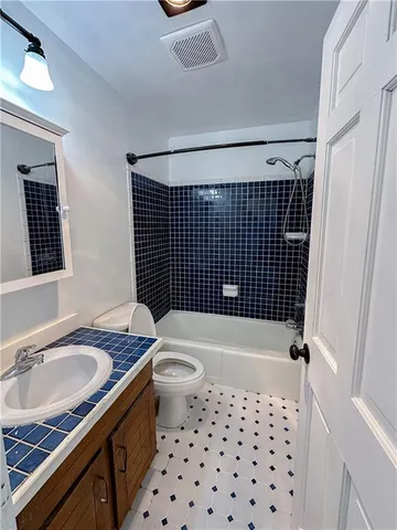a bathroom with a sink toilet a shower and a mirror