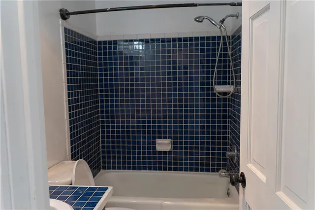a bathroom with a bathtub and shower