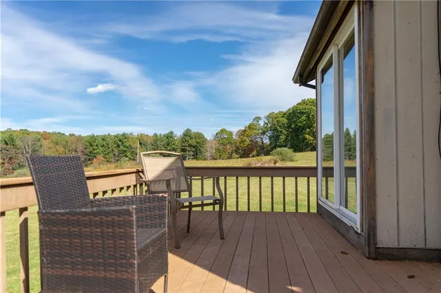 a view of a balcony with wooden floor & fence