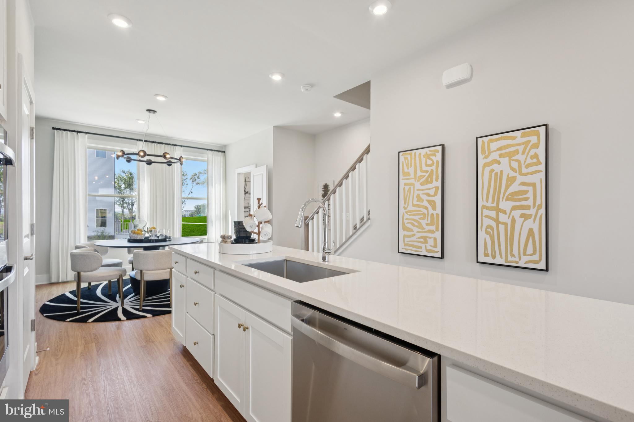 13746 Cobble Loop Woodbridge, VA 22193 - Photo 6 of 27 a kitchen with sink cabinets and wooden floor