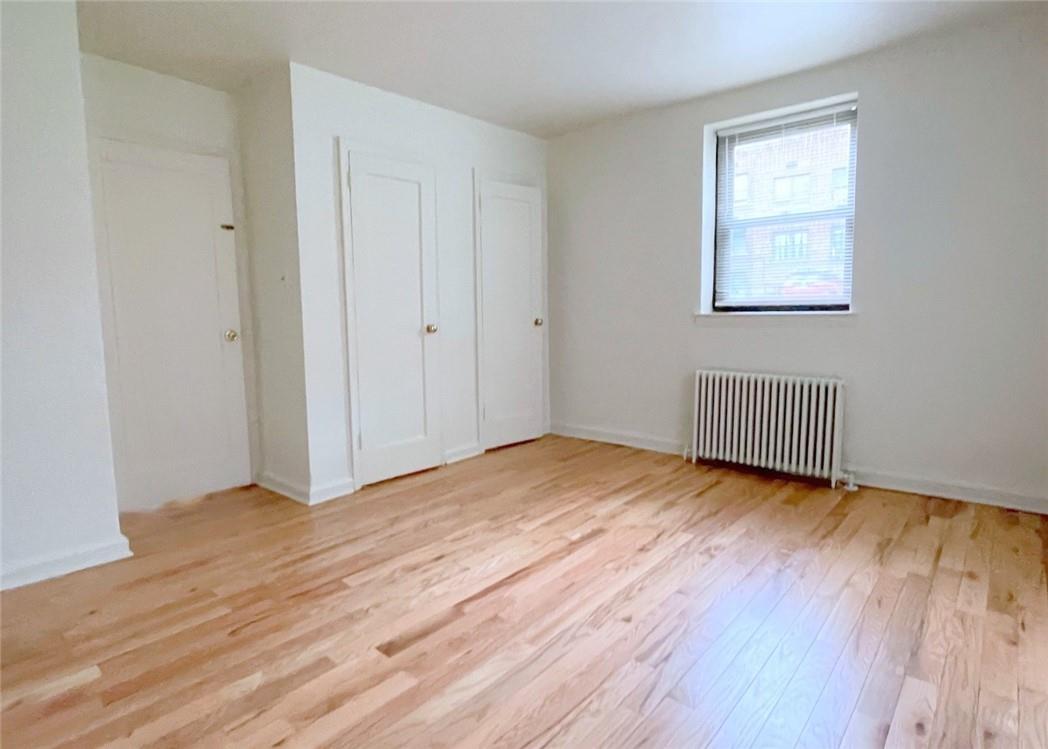 124 Richbell Road, Unit A4 Mamaroneck, NY 10543 - Photo 12 of 18 a view of an empty room with wooden floor and a window