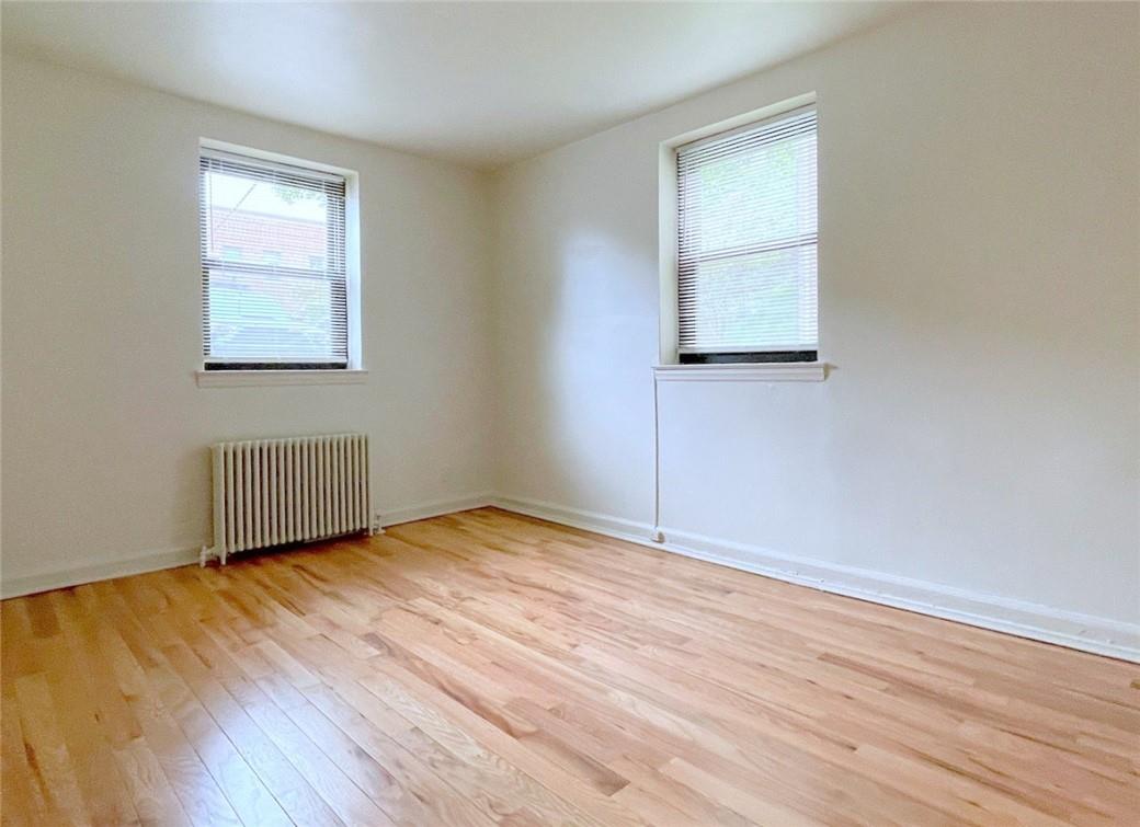 124 Richbell Road, Unit A4 Mamaroneck, NY 10543 - Photo 13 of 18 an empty room with wooden floor and windows