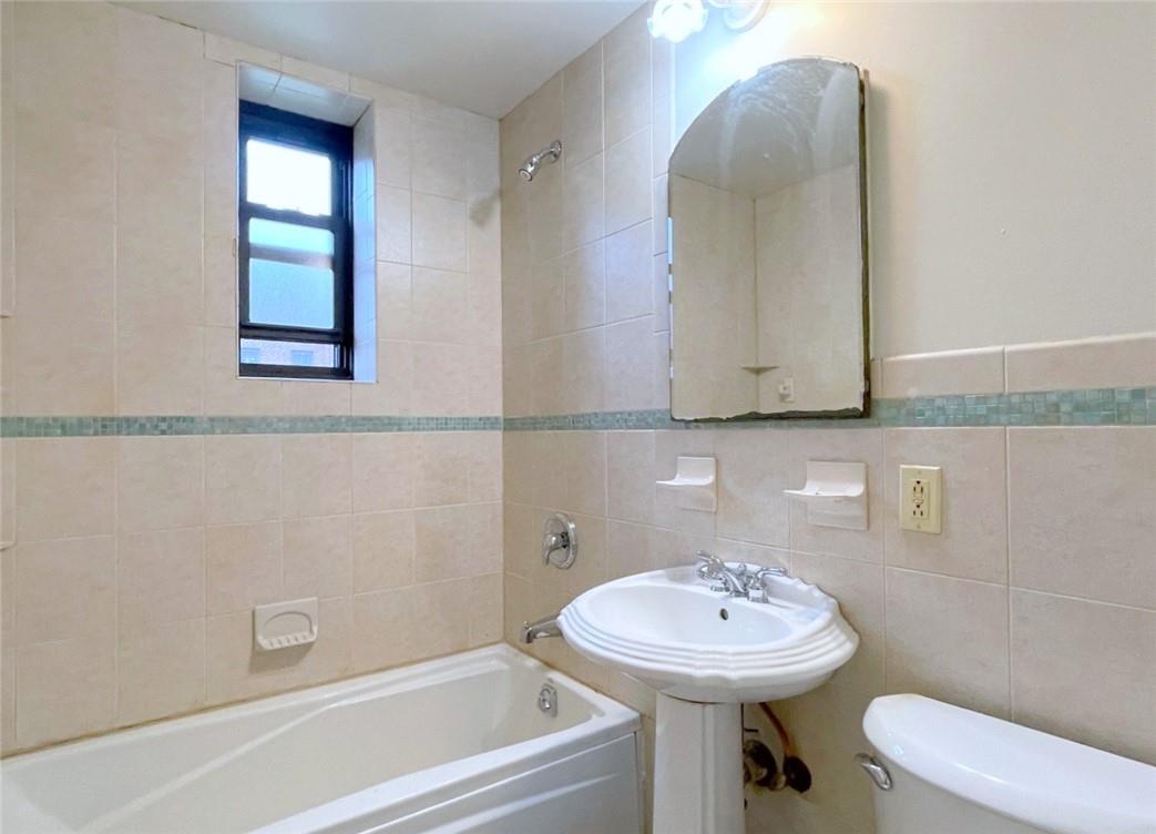 124 Richbell Road, Unit A4 Mamaroneck, NY 10543 - Photo 15 of 18 a bathroom with a sink a toilet and mirror