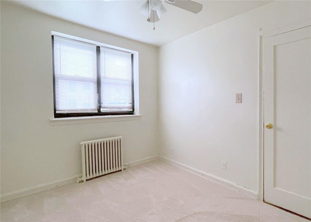 124 Richbell Road, Unit A4 Mamaroneck, NY 10543 - Photo 16 of 18 an empty room with windows and closet