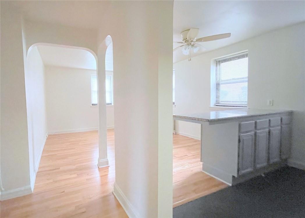 124 Richbell Road, Unit A4 Mamaroneck, NY 10543 - Photo 4 of 18 a view of an empty room with wooden floor and a window