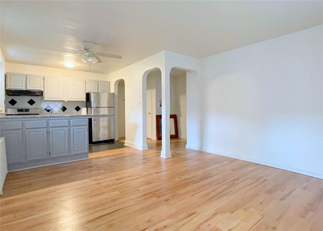 124 Richbell Road, Unit A4 Mamaroneck, NY 10543 - Photo 9 of 18 a view of a kitchen with refrigerator and wooden floor