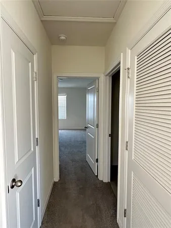 a view of a hallway with a wooden door