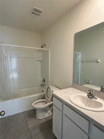 a bathroom with a double vanity sink toilet and shower