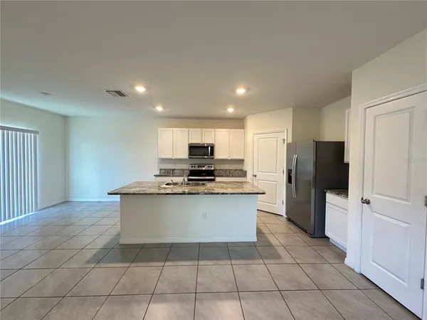a kitchen with stainless steel appliances a sink stove and refrigerator