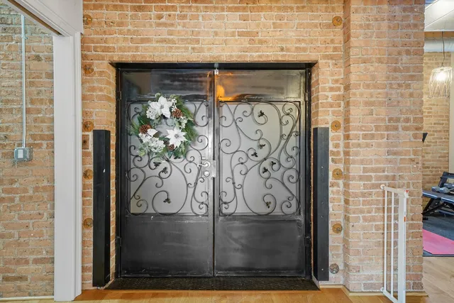 a door with brick wall and potted plants