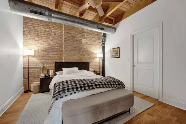 a bedroom with a bed and a flat tv screen on the dresser