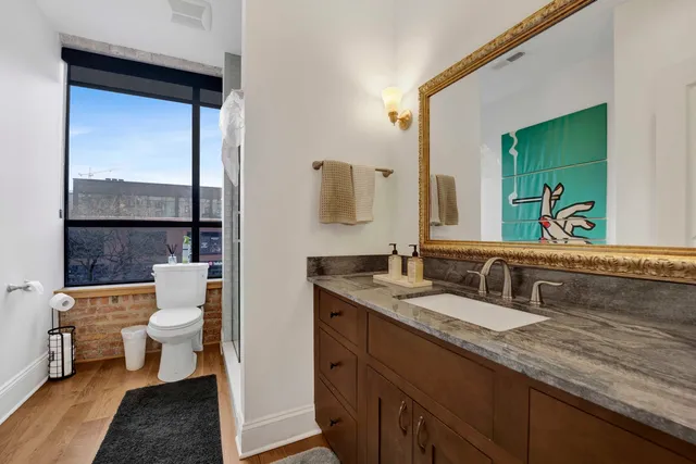 a white toilet sitting next to a bathroom sink