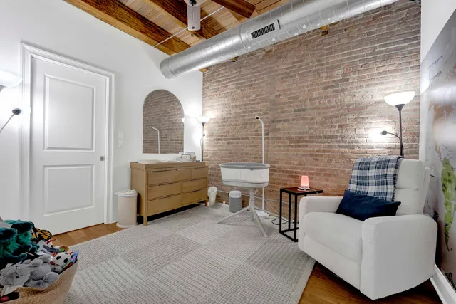 a living room with furniture and a wall painting