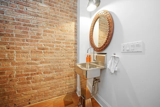 a bathroom with a sink a mirror and a shower